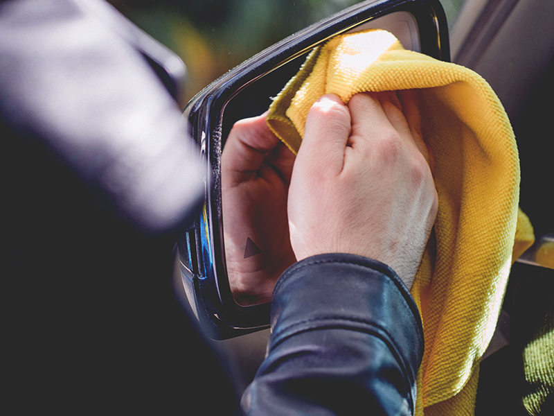 Detailing a vehicle mirror with a microfiber towel